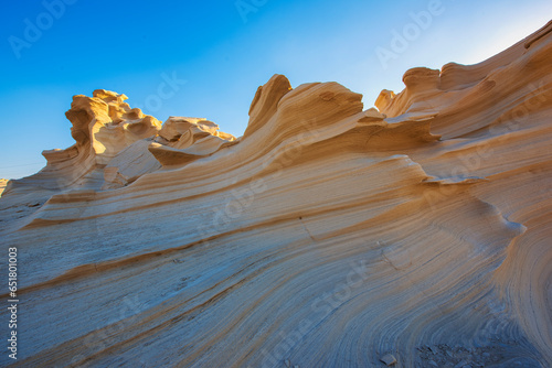 Desert eroded rock pattern with clear sky. Desert rock formation with erosion