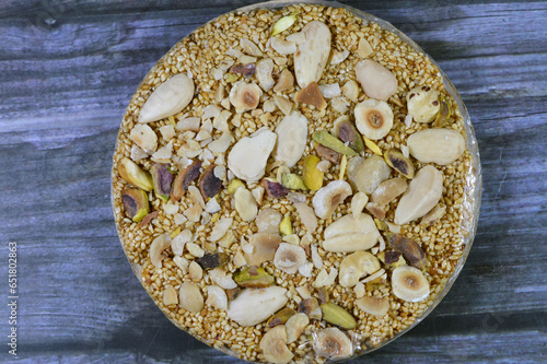 Confectionery sweet circular Eastern candy made of sugar, sesame, nuts, hazelnuts, almonds and pistachios, a special dessert disc as a celebration of Maloud Mawled Nabawy or the prophet's birth photo