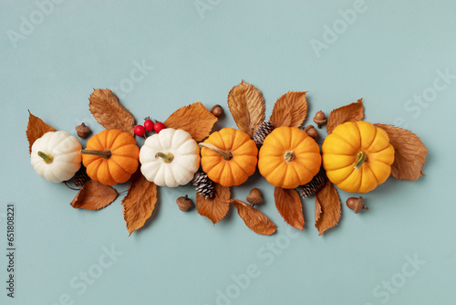 Happy Thanksgiving holiday background from autumn foliage, pumpkins and fall decorations top view. .