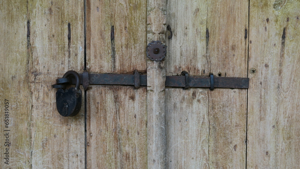 Padlock on old wooden gate Padlock on old wooden gate