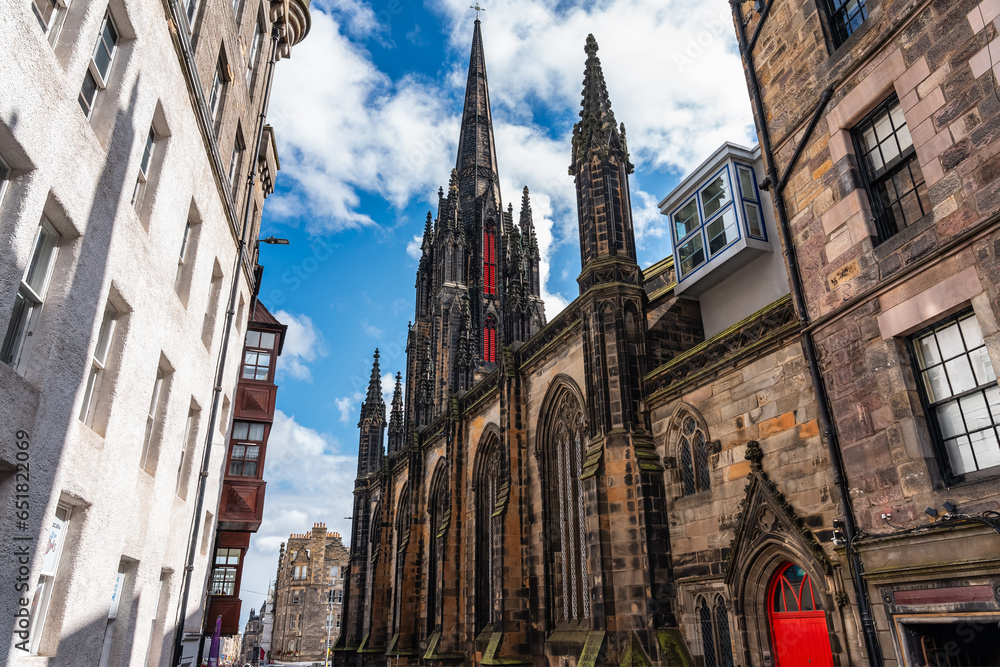 Cathedral with high tower and historic buildings on Castlehill Avenue in Edinburgh, Scotland