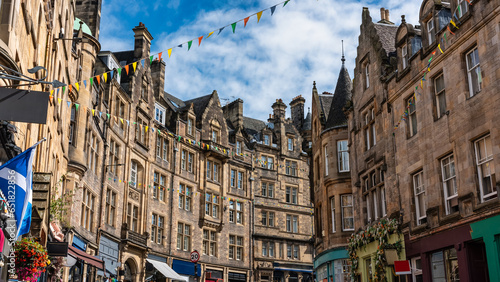 Cockburn shopping street with colorful shops and old stone buildings in Edinburgh, Scotland. photo