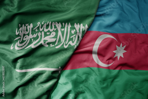 big waving realistic national colorful flag of saudi arabia and national flag of azerbaijan .