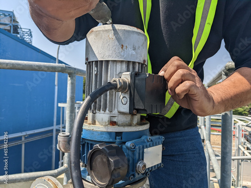 Bild auf Leinwand Check wiring electrical agitator motor with technician on power plant industry