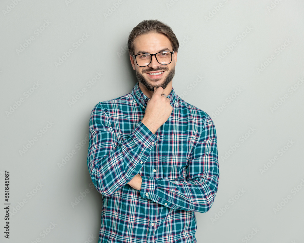 confident happy man with glasses folding arms, smiling and dreaming confident happy man with glasses folding arms, smiling and dreaming