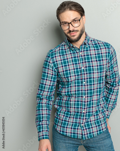 happy casual man with glasses wearing plaid shirt and smiling