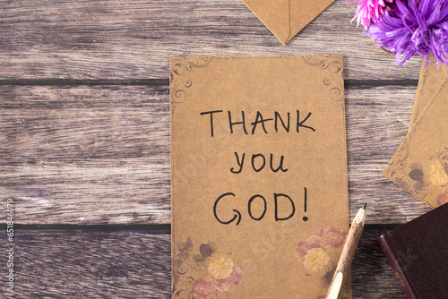 Thank You, God, handwriting on old vintage paper with rustic pen and holy bible book on wooden background. Top table view. Christian thanksgiving, gratitude, blessing, and praise to Jesus Christ. photo