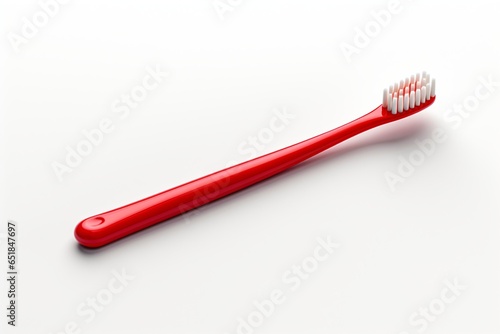 red toothbrush isolated on a plain grey background