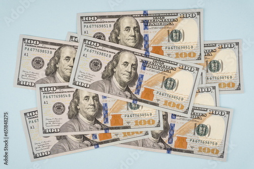 100 dollar bills on a blue background