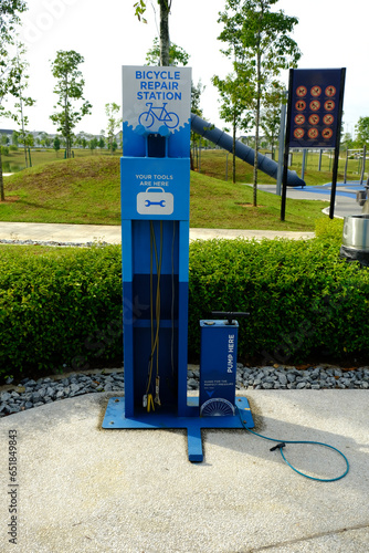 A picture of public park bicycle repair station used for self repair by cyclist. photo