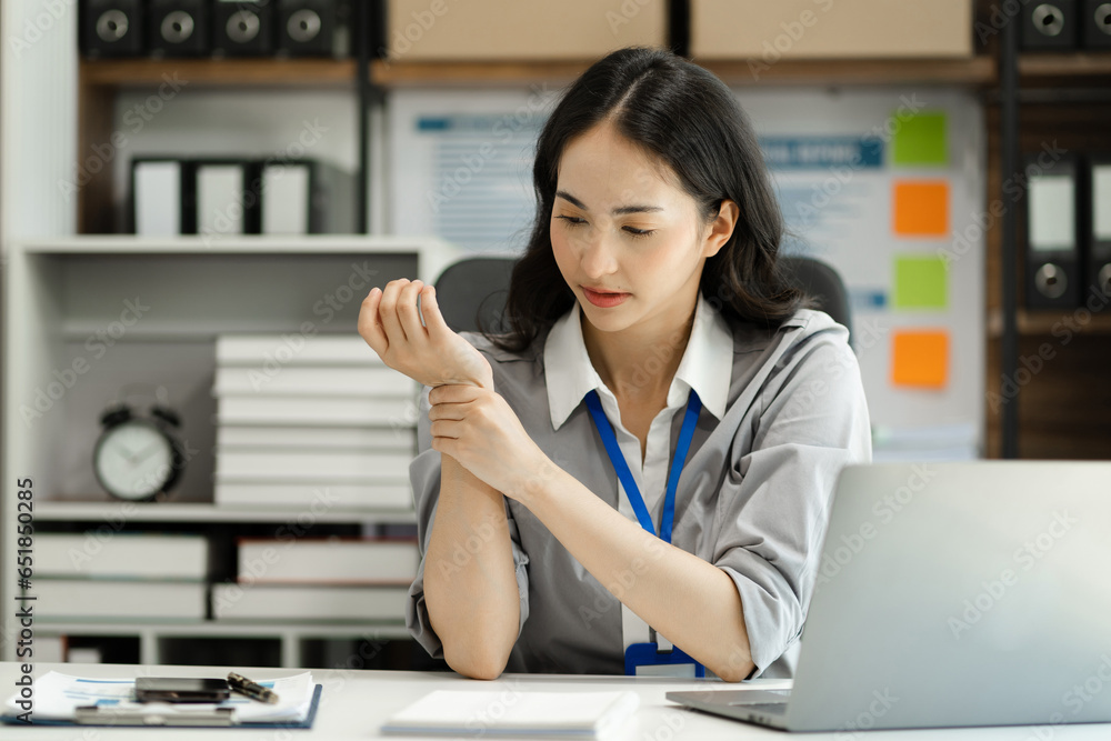 Woman have wrist pain after work hard in office feeling so pain and illness with Office syndrome