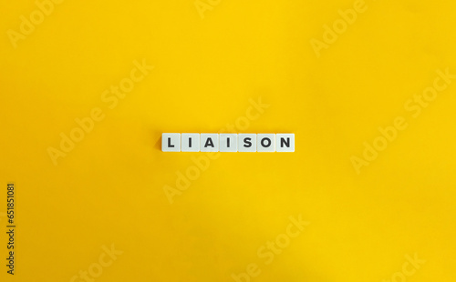 Billede på lærred Liaison Word on Letter Tiles on Yellow Background