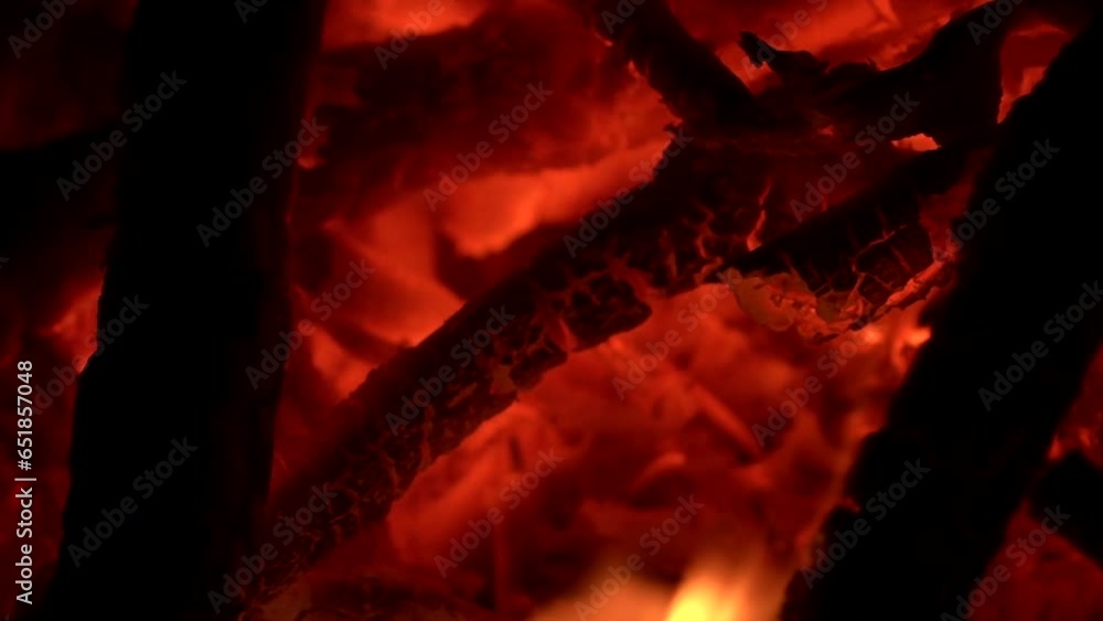 Fire burning in night. Loopable, yellow and orange color flame giving, light, black, wood, woods, tree, trees, detail, falmes, nature, dark, slow motion, motion, mid shot, close up, hd. ProRes 422HQ.