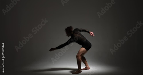 Wallpaper Mural An energetic dancer of Caucasian origin exudes enthusiasm as they dance in shorts against a subtle gray backdrop. Their dynamic movements create a visually engaging and lively performance. Torontodigital.ca