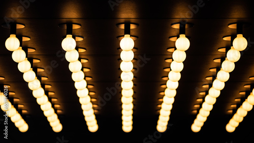 Rows of illuminated globes under the marquee, as often used at the entrance to theatres and casinos