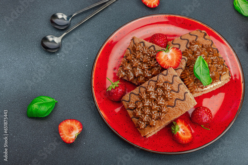 Delicious chocolate cakes with fresh strawberries. Sweet dessert, good morning concept photo