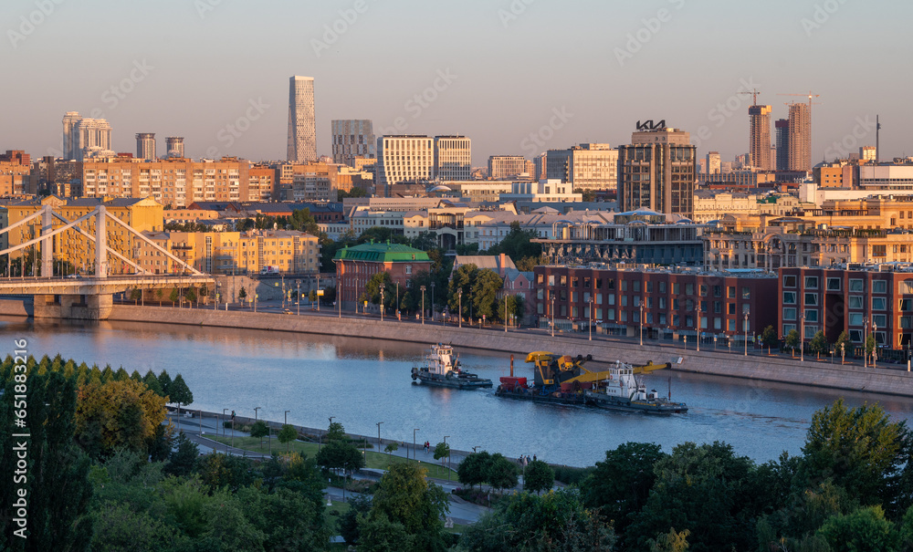 July 16, 2022, Moscow, Russia. Tugs pull a construction crane along the Moscow River