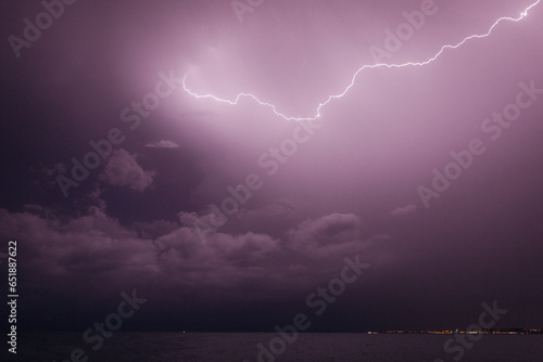 Lightning over the sea in a resort town at night