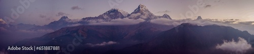 Panoramic view of the Himalayan mountain range with the world's highest peaks covered in snow at sunset © Cjsierrah
