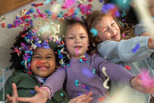 Portrait happy friend school girl children student, kid, child having fun activity play party, festive and event celebration with colorful confetti, birthday, new year, children day at school