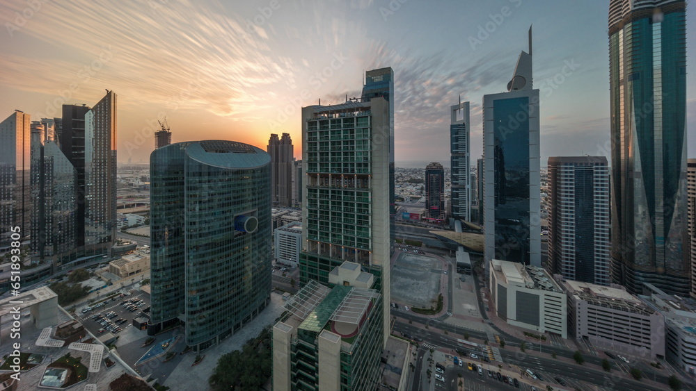 Fototapeta premium Dubai international financial center skyscrapers with cloudy blue sky aerial all day.