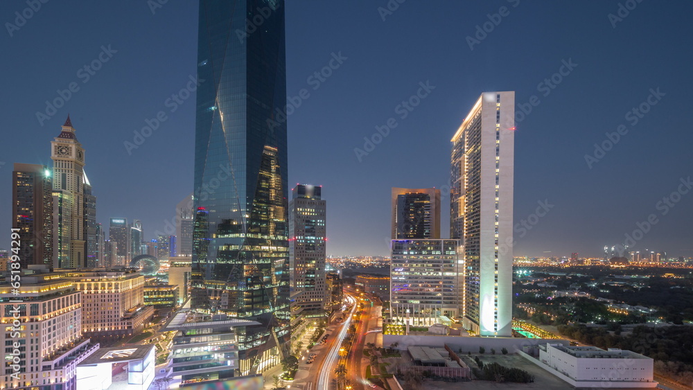 Obraz premium Dubai International Financial district aerial day to night. Panoramic view of business and financial office towers.
