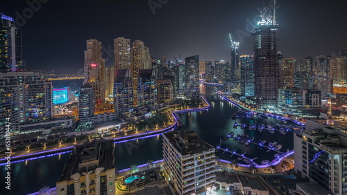 Panorama showing Dubai Marina skyscrapers and JBR district with luxury buildings and resorts aerial night