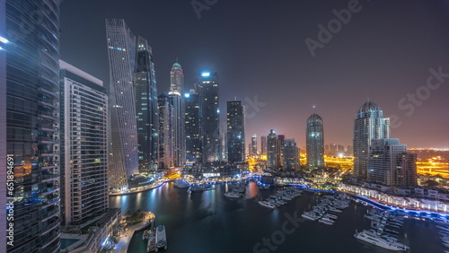 Canvas Print Dubai marina tallest skyscrapers and yachts in harbor aerial all night