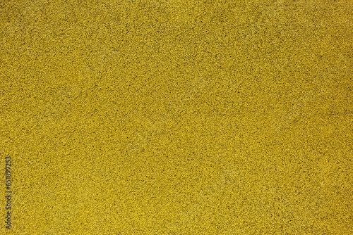 Grainy yellow texture made of rubber tiles