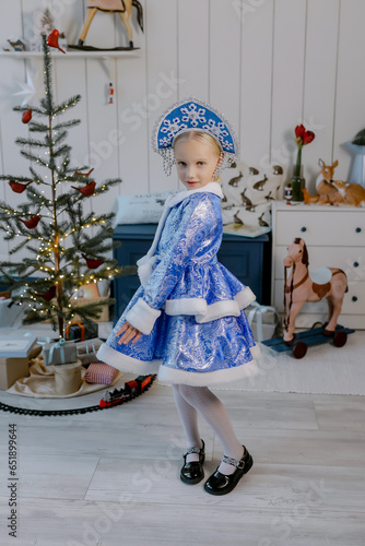 Little girl in a dress for Christmas. New Year's outfit.