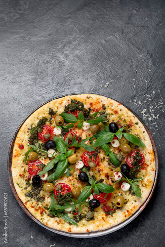 Delicious pizza with cherry tomatoes and fresh basil.