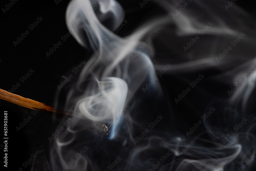 Smoke from a match that was just put out, isolated on black background Smoke from a match that was just put out, isolated on black background