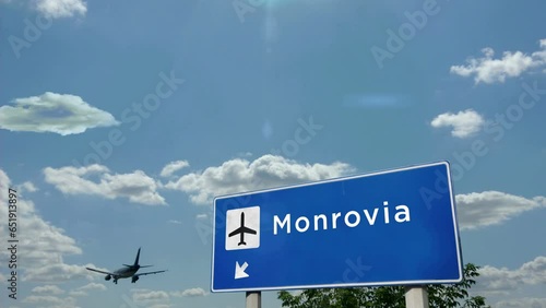 Jet airplane landing in Monrovia, Liberia. Plane city arrival with airport direction sign. Travel, business, tourism and plane transport concept.