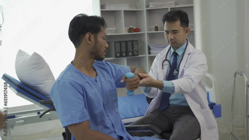A Man do exercises with elastic band, Physiotherapy Program, Healthcare Concept Doctor helping patient in wheelchair with dumbbells doing rehabilitation exercise in medical center A Man do exercises with elastic band, Physiotherapy Program, Healthcare Concept Doctor helping patient in wheelchair with dumbbells doing rehabilitation exercise in medical center