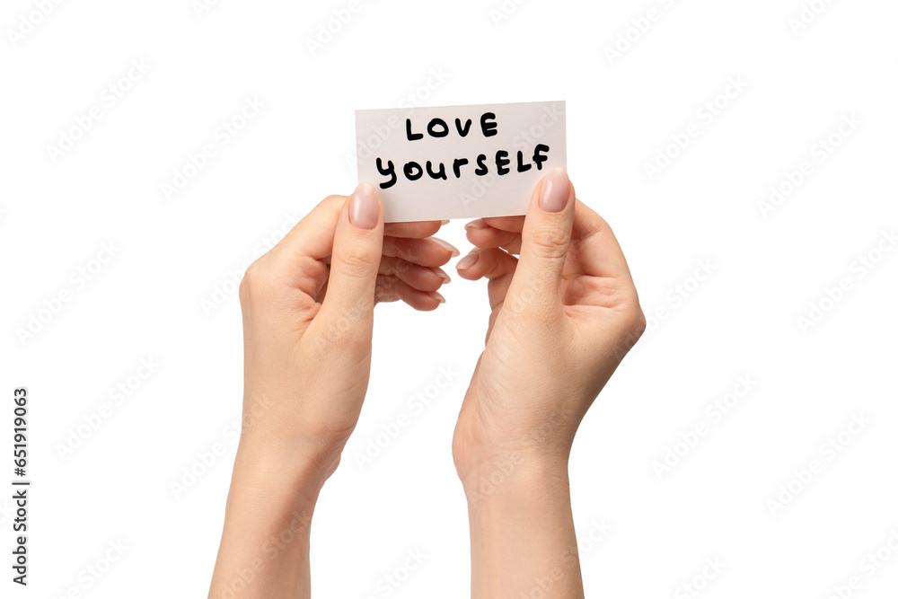 Love yourself text on a card in a woman hand isolated. Love yourself text on a card in a woman hand isolated.