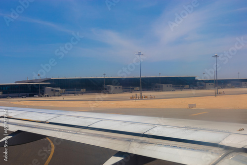 View from an airplane window on the Hurghada airport building on a clear sunny summer day photo