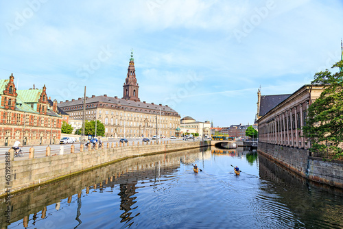 Copenhagen, Denmark - June 26, 2019: two kayaking in a canal in the center of the capital of Denmark, Copenhagan. Against the background of Christiansborg Castle photo