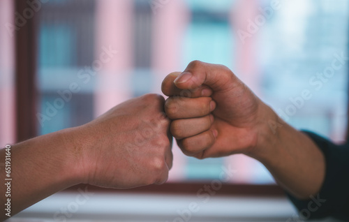 two man clashed fists of the other hand. Confrontation concept, business dealing agreement contract, success negotiation, greeting partner or friendship, offering helping hand teamwork cooperation