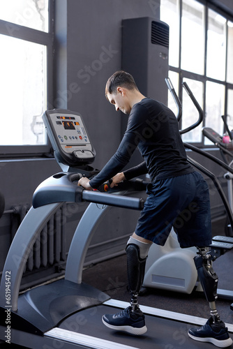 love of life. man concentrated on walking on treadmill, side view shot lifestyle hobby interest