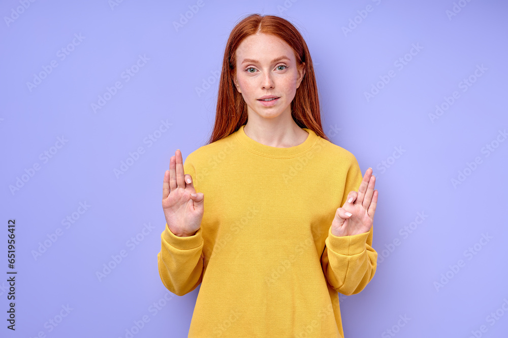 young good-looking ginger girl learning body language, isolated blue background, closeup portrait, deaf girl saying the word family