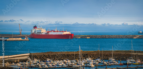 Obraz na płótnie LNG carrier moored by pier in port on hazy evening. w salonie