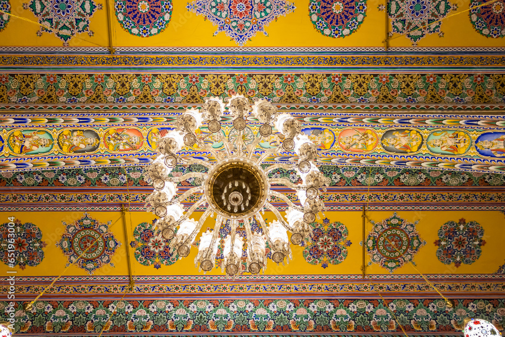 artistic design of temple roof with lighted Chandelier from low angle