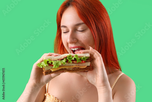Young redhead woman eating ...