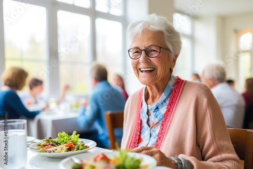 Portrait of a senior woman in a retirement home happily enjoying a healthy lunch. Presentation of a healthy lifestyle of well-being and contentment even at an age photo