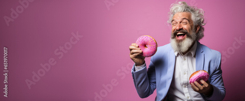 Innovative artist savouring a donut during brainstorming isolated on a gradient background 