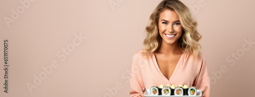 Millennial woman cheerfully eating sushi isolated on a white urban background 