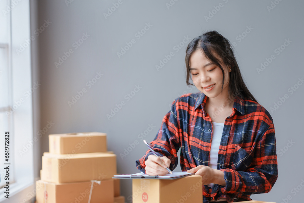 E-commerce Entrepreneurship. Asian Female Online Seller Packing Orders for Internet Sales. Efficient Online Sales. Asian Female owner Packaging Products for Delivery. E-commerce Entrepreneurship. Asian Female Online Seller Packing Orders for Internet Sales. Efficient Online Sales. Asian Female owner Packaging Products for Delivery.