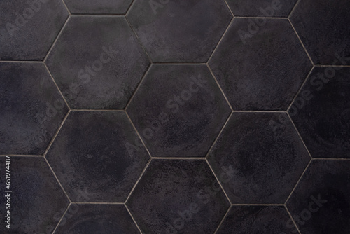 Gray hexagonal tile. Wall cladding with granite. Background, tile texture.