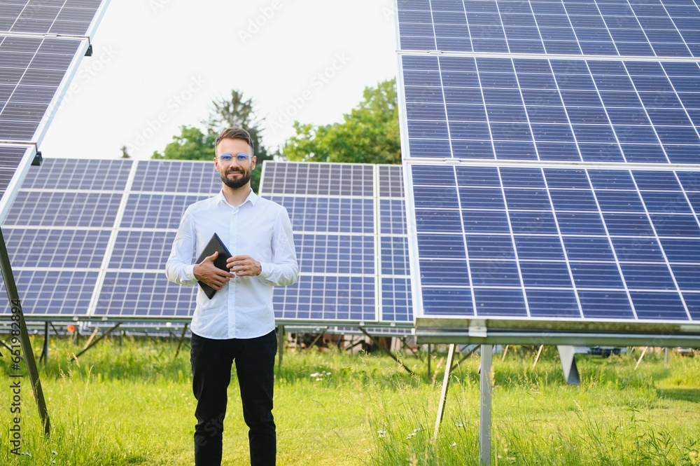Fototapeta premium Solar power plant. Engineer on a background of photovoltaic panels. Science solar energy