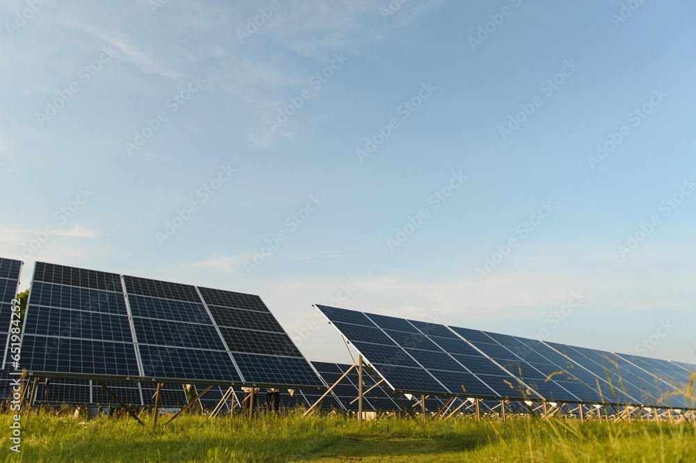 Solar panels and blue sky. Solar panels system power generators from sun. Clean technology for better future Solar panels and blue sky. Solar panels system power generators from sun. Clean technology for better future